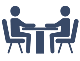 A blue icon of two people sitting at a table for an interview