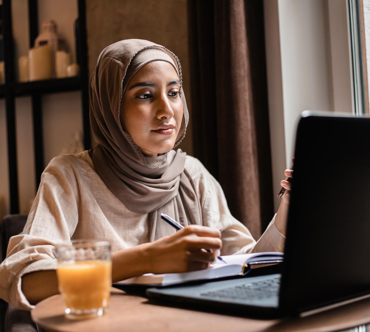 Muslim woman at computer - GettyImages-1451261997