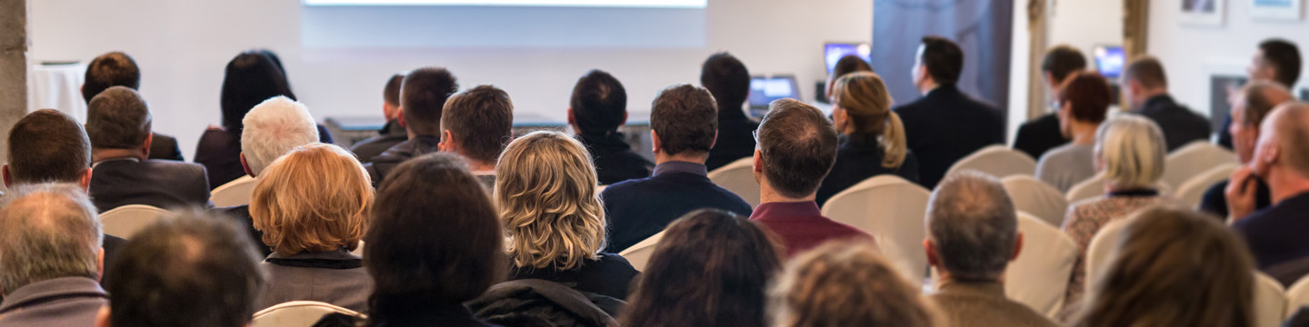 people seated in a meeting room