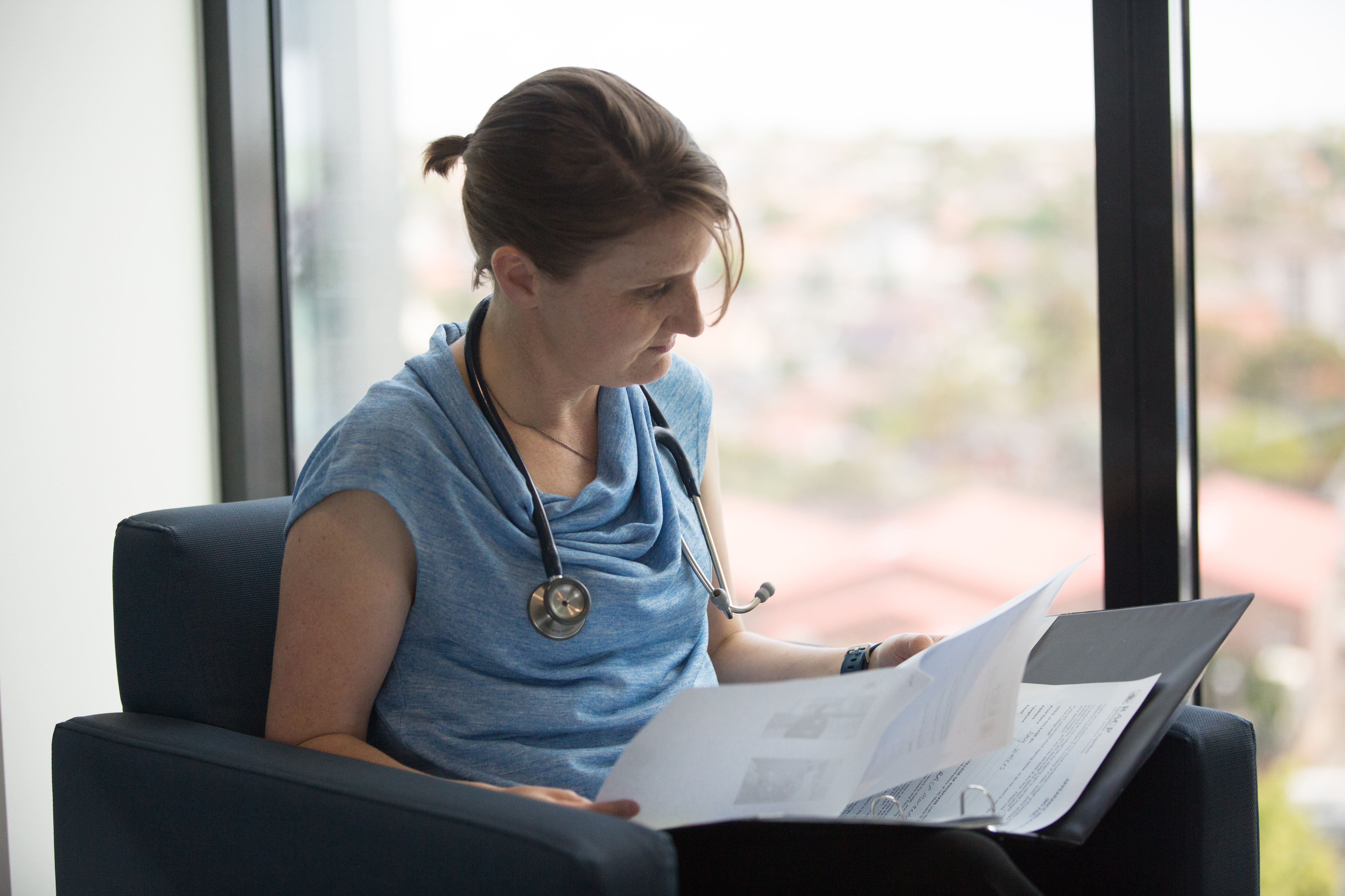Photo of Dr Amy Waters reading documents