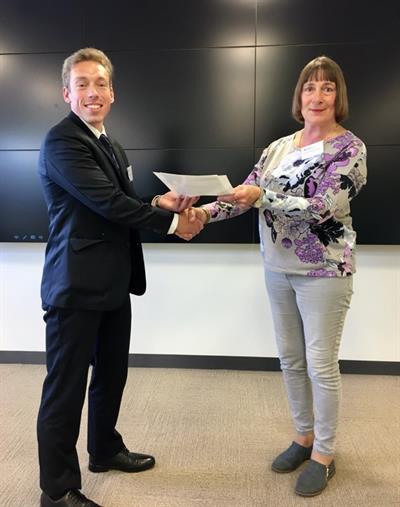 Dr Michael Thompson receiving his winners certificate and letter from conference MC Dr Evelyn Bowles-Funk Dr Michael Thompson receiving his winners certificate and letter from conference MC Dr Evelyn Bowles-Funk