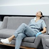 Tired female doctor resting on couch