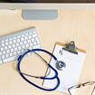 computer and stethoscope on a table